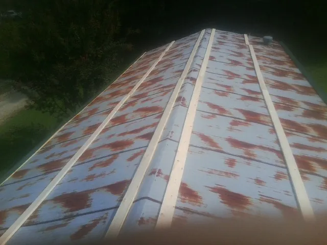 Rusted metal roof panels with new wood purlins before replacement — Storm Damage Roof Repair in Gunpowder by Roofing Brothers