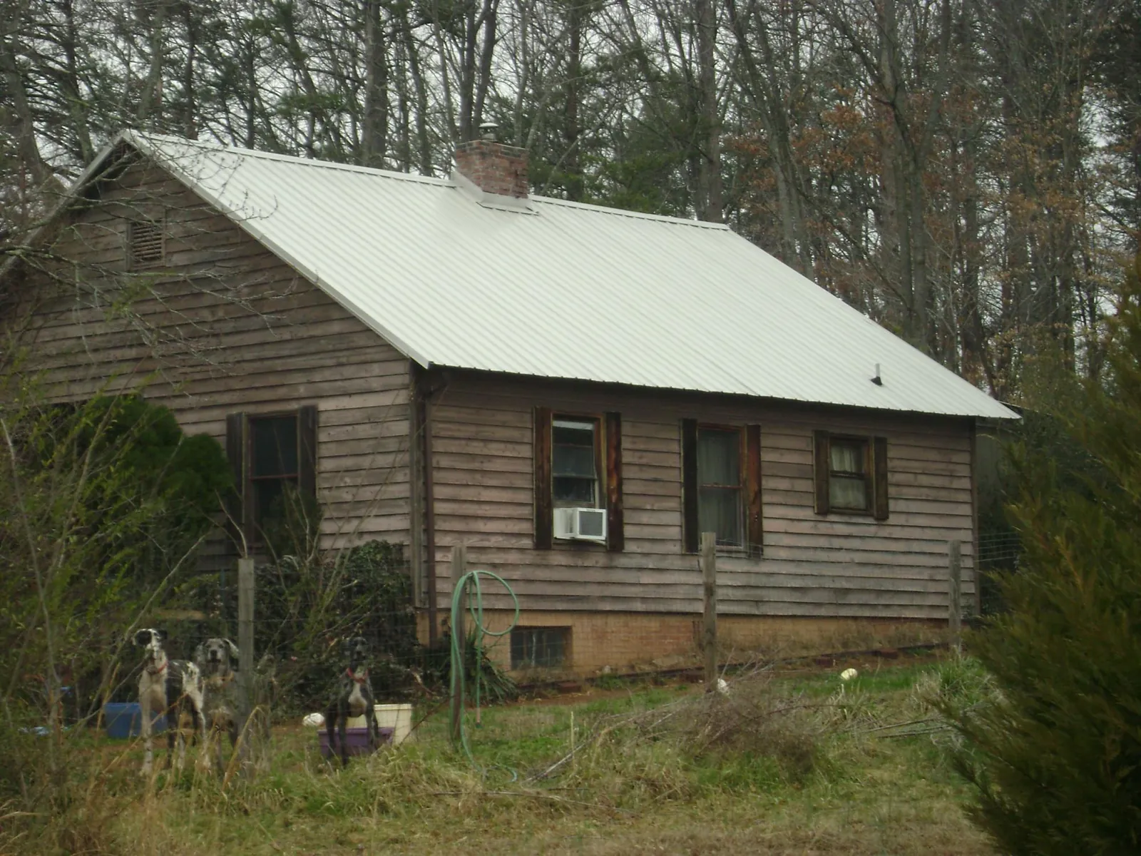 White metal roof on an old wood sided farmhouse, from a Metal Roof Installation job in Gunpowder